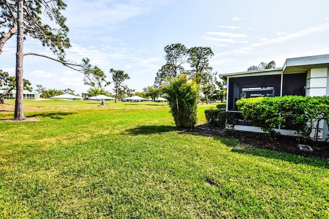 view of yard featuring a sunroom