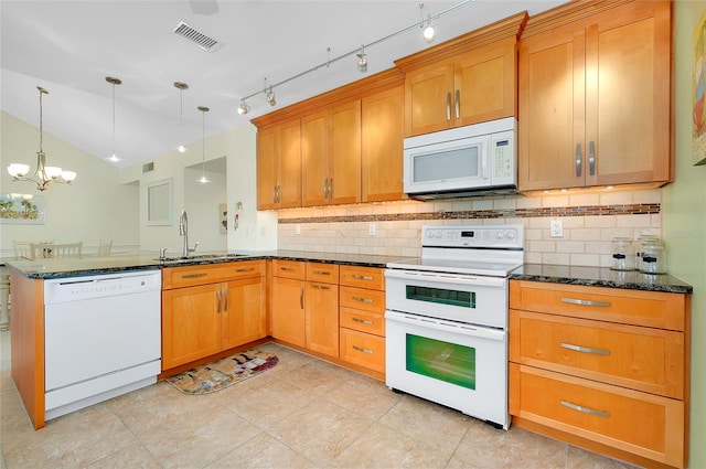 kitchen featuring sink, hanging light fixtures, dark stone countertops, kitchen peninsula, and white appliances