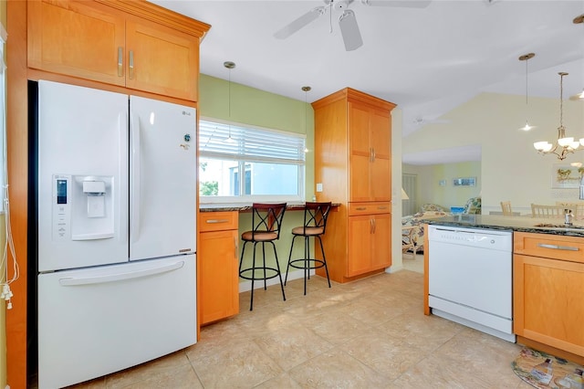 kitchen featuring stone counters, ceiling fan with notable chandelier, white appliances, and decorative light fixtures