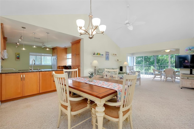 dining room with high vaulted ceiling, sink, light colored carpet, and ceiling fan