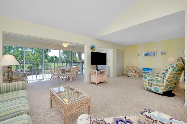 living room with lofted ceiling, light colored carpet, and ceiling fan