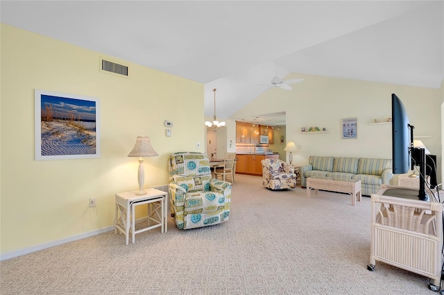 living room featuring lofted ceiling, carpet flooring, and ceiling fan with notable chandelier