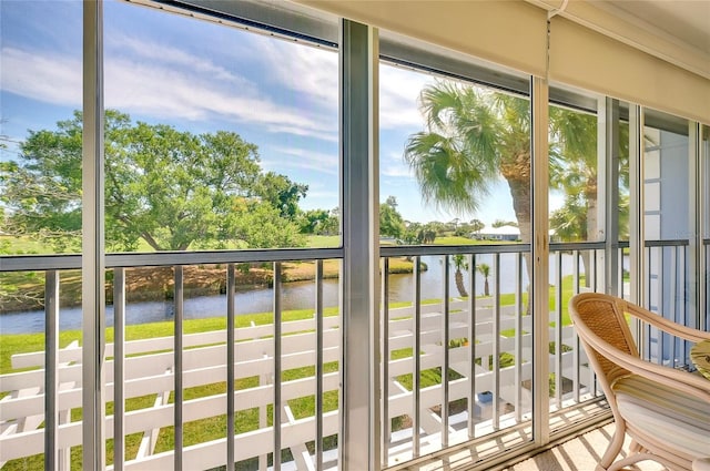 unfurnished sunroom with plenty of natural light and a water view