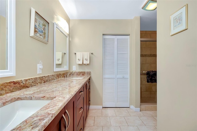 bathroom featuring tile patterned floors, vanity, and a shower with shower door