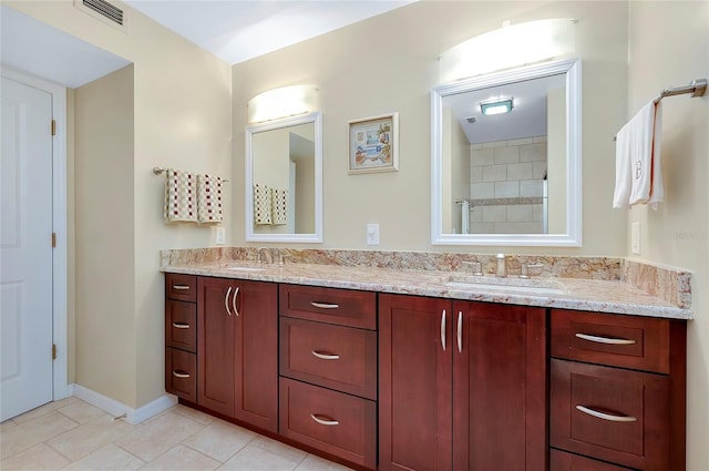 bathroom featuring tile patterned floors, vanity, and a shower