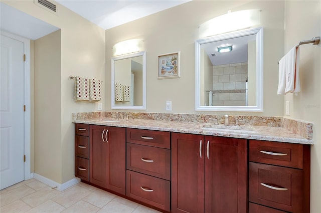 bathroom featuring tile patterned flooring, visible vents, a sink, and double vanity