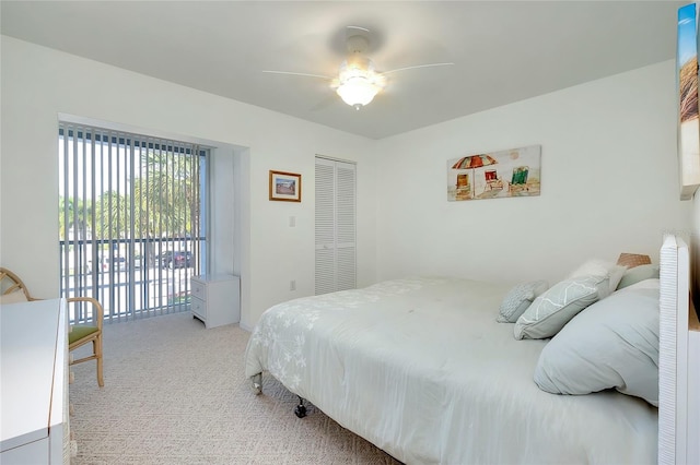 bedroom featuring light carpet, access to outside, a closet, and a ceiling fan