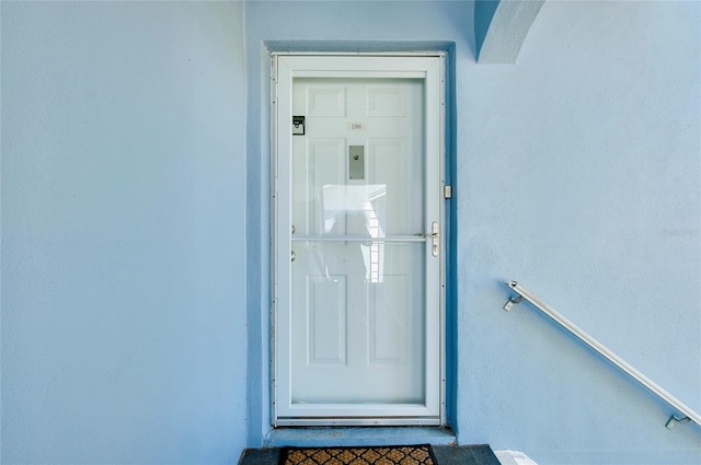 doorway to property with stucco siding