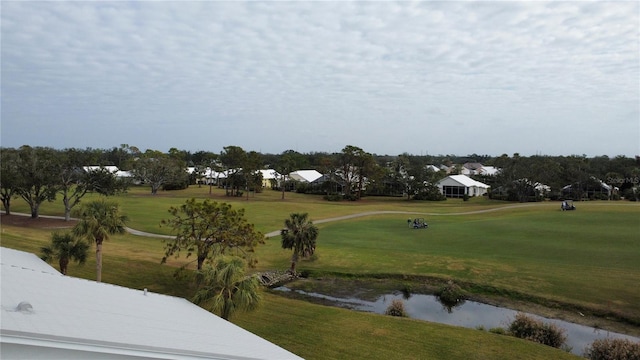 view of community with a water view and a lawn