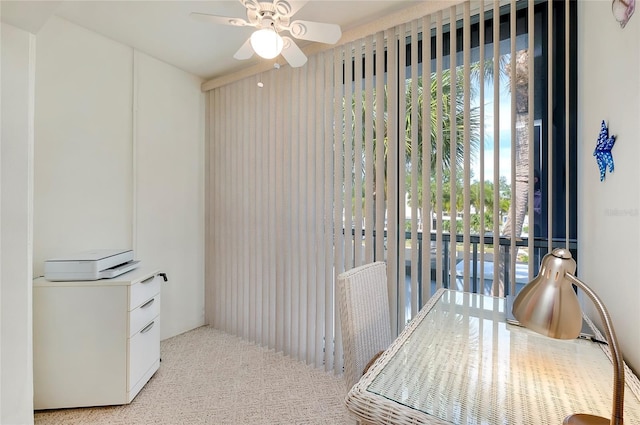 interior space featuring a ceiling fan and light colored carpet