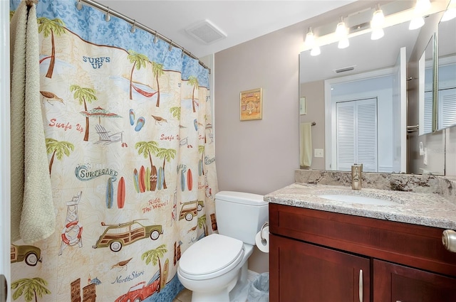 bathroom featuring a closet, visible vents, vanity, and toilet