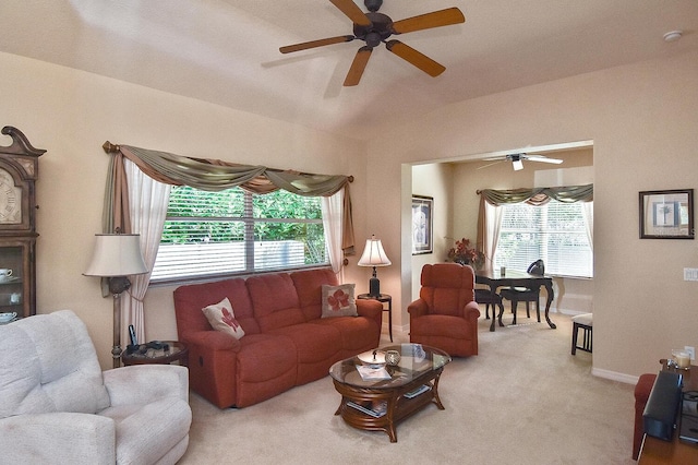 living room with ceiling fan, lofted ceiling, light colored carpet, and a healthy amount of sunlight