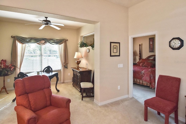 sitting room featuring light carpet and ceiling fan