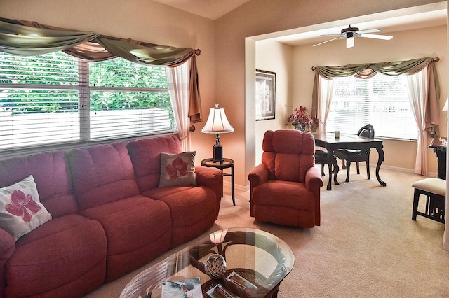 living room with ceiling fan, a wealth of natural light, and light colored carpet