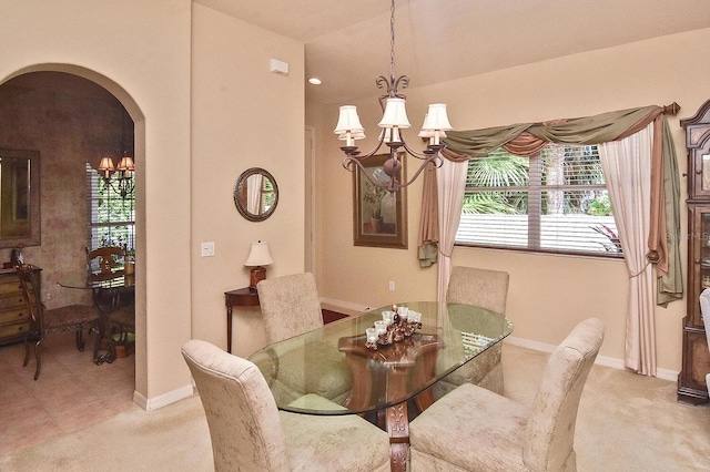 tiled dining room featuring a chandelier