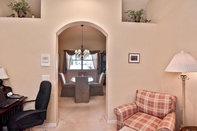 office space featuring a notable chandelier and light colored carpet