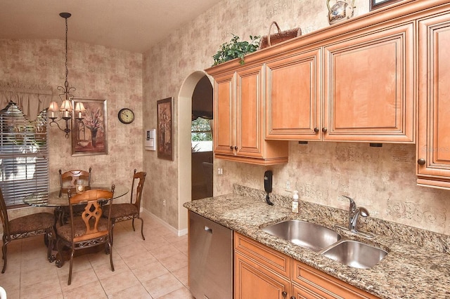 kitchen with decorative light fixtures, a chandelier, stone countertops, sink, and light tile flooring