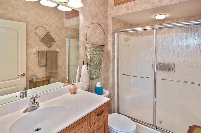 bathroom with an enclosed shower, toilet, and vanity