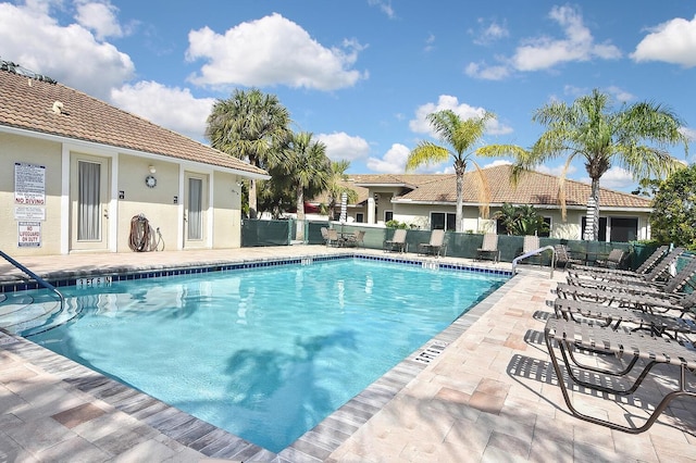 view of swimming pool featuring a patio area