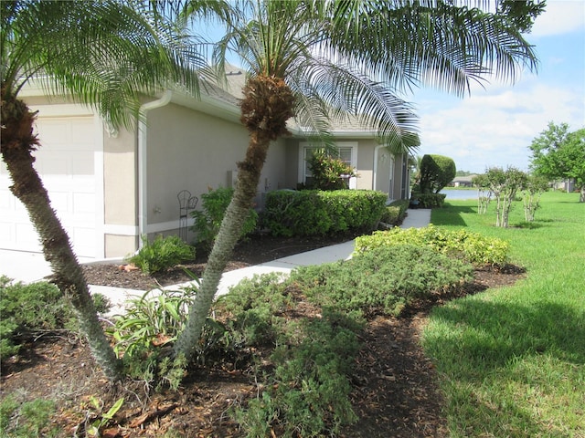 view of home's exterior featuring a yard and a garage