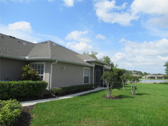 view of side of home with a lawn