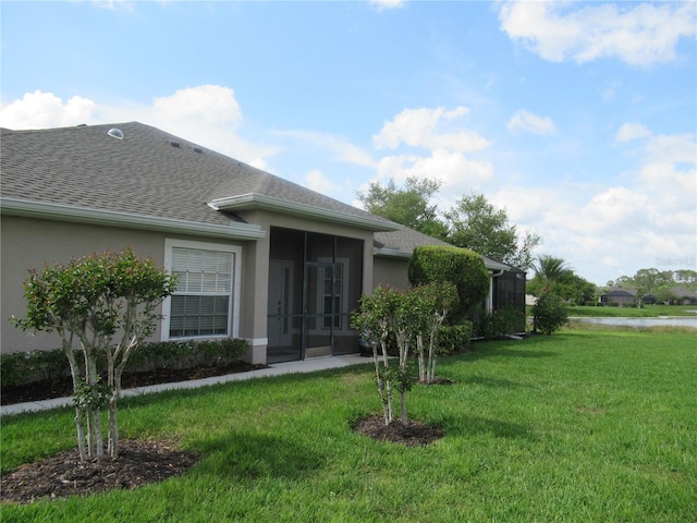 view of front of home featuring a front yard and a sunroom