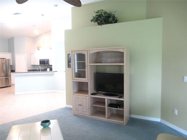 unfurnished living room with carpet floors and sink