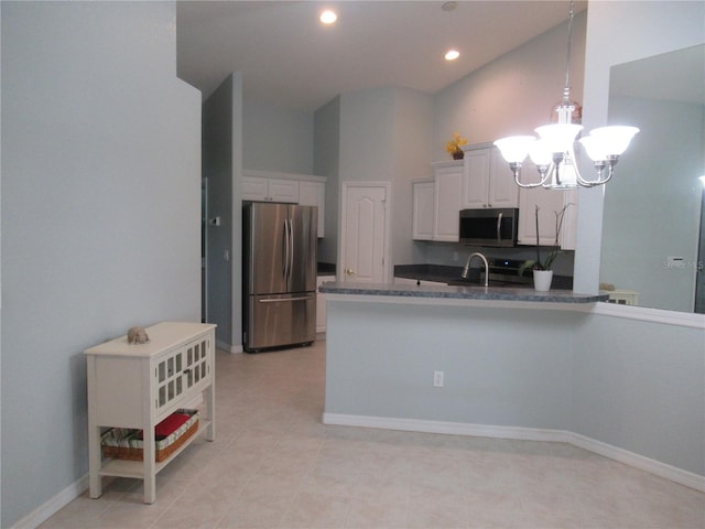 kitchen featuring decorative light fixtures, white cabinetry, a notable chandelier, appliances with stainless steel finishes, and light tile floors