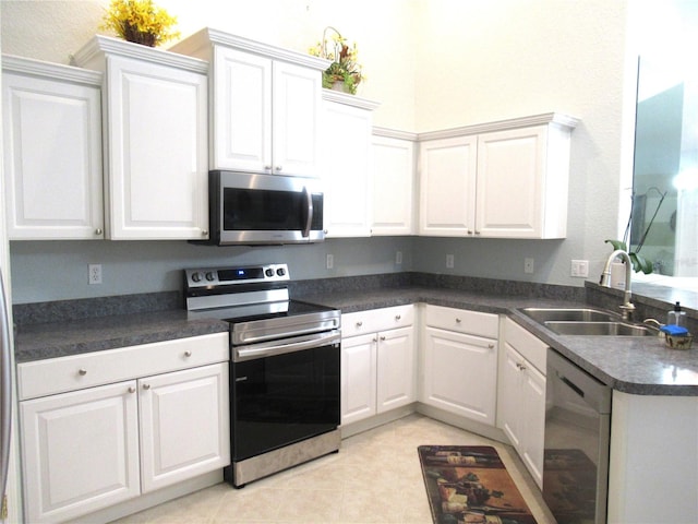 kitchen with white cabinets, stainless steel appliances, light tile floors, and sink