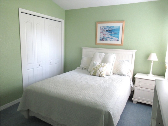 bedroom featuring dark carpet and a closet