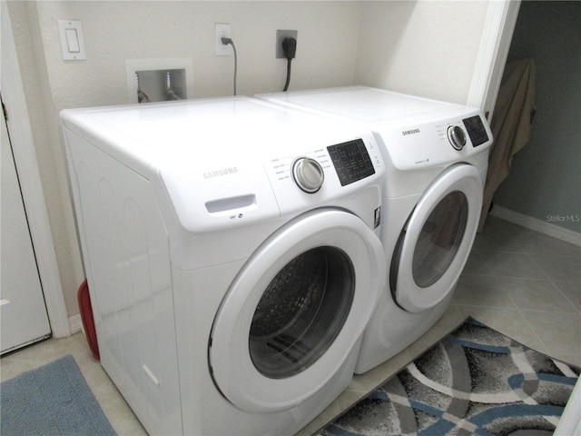 washroom featuring hookup for a washing machine, hookup for an electric dryer, independent washer and dryer, and light tile floors