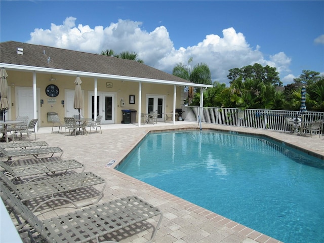 view of pool featuring french doors and a patio