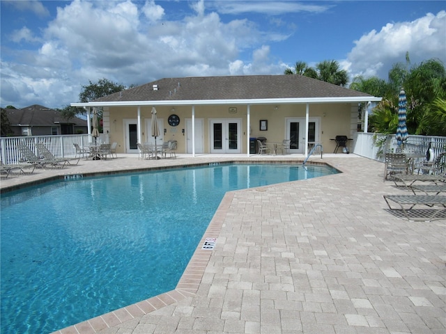 view of swimming pool with a patio area and french doors