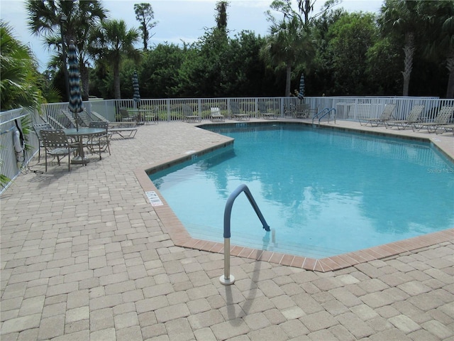 view of swimming pool featuring a patio area