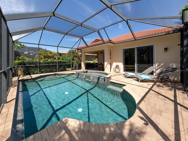 view of pool featuring an in ground hot tub, glass enclosure, and a patio