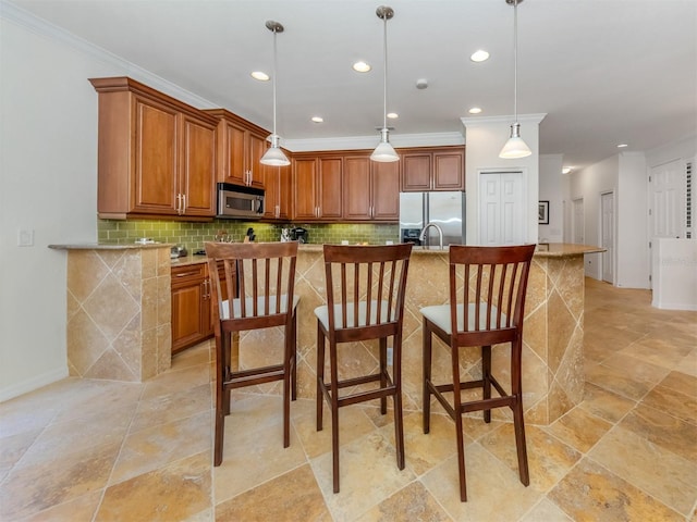 kitchen with a kitchen breakfast bar, hanging light fixtures, stainless steel appliances, and light tile flooring