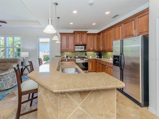 kitchen featuring pendant lighting, sink, backsplash, stainless steel appliances, and light tile flooring