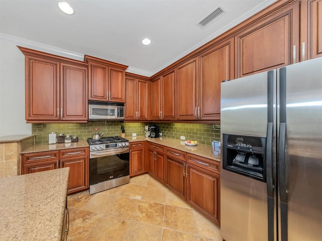 kitchen with light stone countertops, backsplash, stainless steel appliances, light tile floors, and crown molding