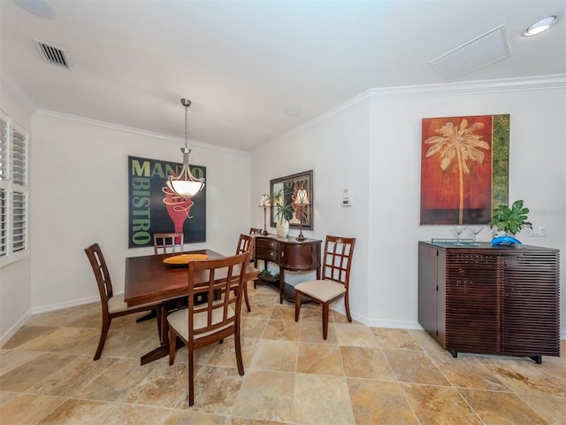 dining space with light tile floors and crown molding