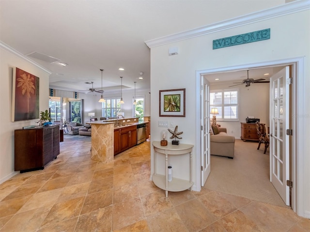 interior space featuring hanging light fixtures, ceiling fan, dishwasher, and a wealth of natural light