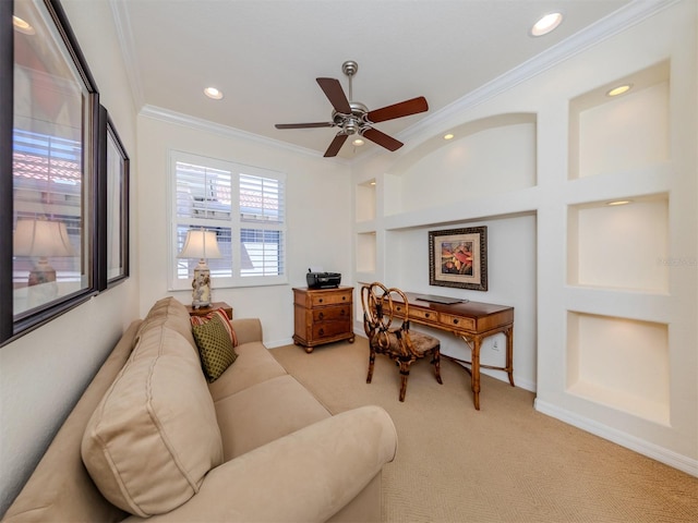 living room with crown molding, built in features, light colored carpet, and ceiling fan