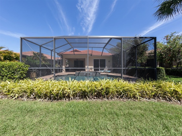 exterior space featuring a lawn and a lanai