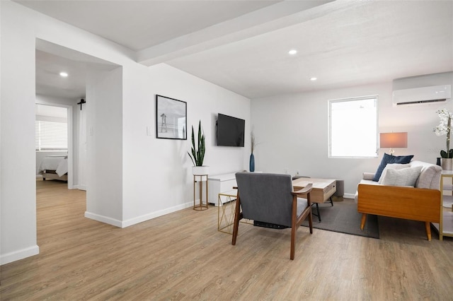 living room featuring a wall mounted AC and light hardwood / wood-style floors