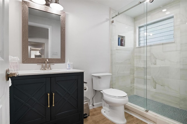 bathroom featuring an enclosed shower, vanity, wood-type flooring, and toilet