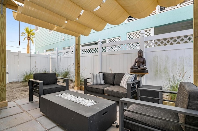 view of terrace featuring an outdoor living space with a fire pit