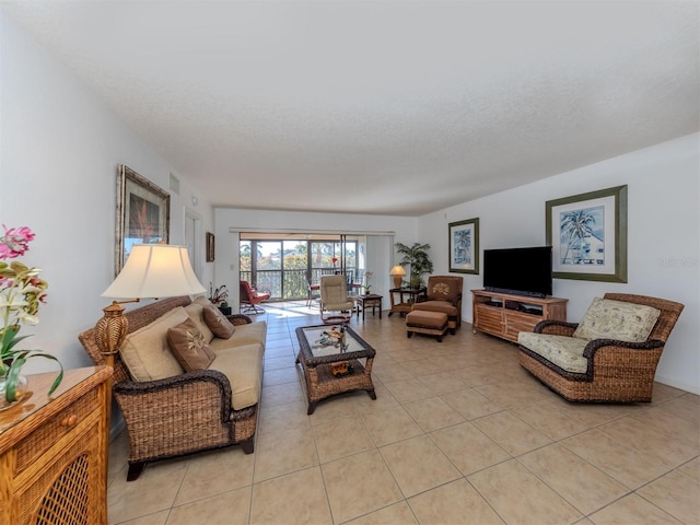 living room with light tile patterned floors and a textured ceiling