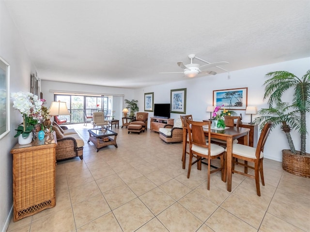 dining area featuring ceiling fan, light tile patterned floors, and a textured ceiling