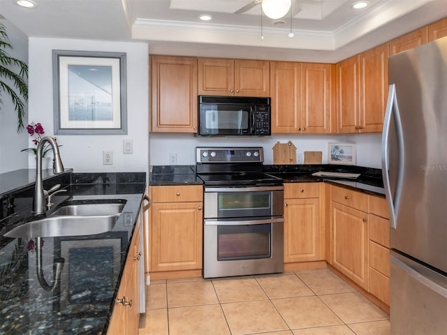 kitchen featuring ornamental molding, stainless steel appliances, a tray ceiling, sink, and light tile patterned floors