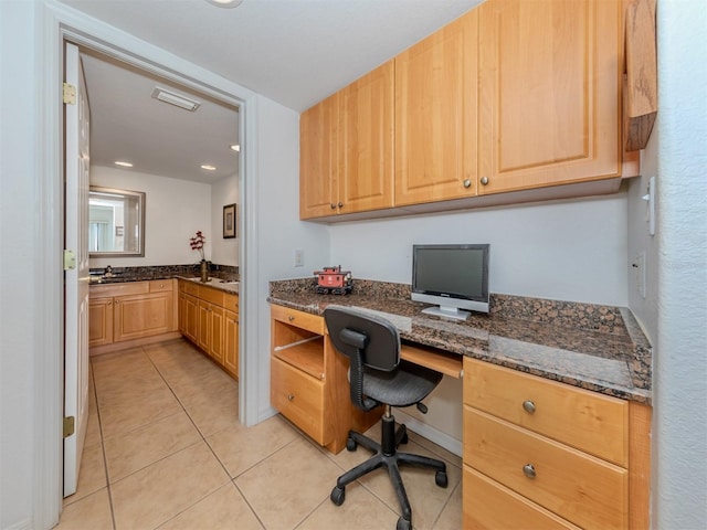 tiled office featuring built in desk and sink