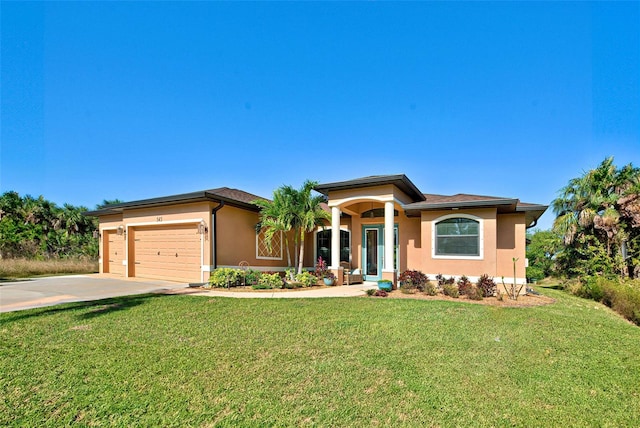 prairie-style house with a front yard and a garage